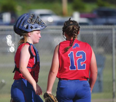 Chandler catcher Hannah Edmonds confers with freshman pitcher Keelie Treat during the Lady Lions’ win over Stroud at the Cushing tournament. Treat and Grace Hulsey combined to win five games, threw three shutouts and allowed only eight runs in the tournament. Photo/Brian Blansett