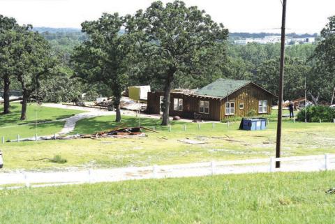 A view of the mess hall at the Chandler Baseball Camp from Oak Park Cemetery. The building was damaged in Friday night’s storms that swept through Lincoln County. Several trees were knocked down and the roof of the nearby residence was also damaged. Photo/Emily Kalka