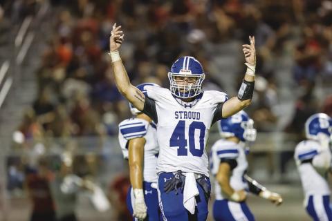 Stroud senior Kason Presley urges the Stroud crowd to get noisy Friday night during the Tigers’ win the annual rivalry game with Chandler. Photo/Rick Hester