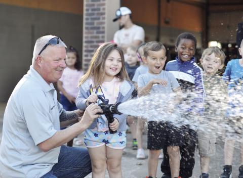 Last Friday, the Stroud Pre-K classes visited the local fire station. The students were able to get an up close experience with spraying the water! Pictured above is Elora McDoulett getting her chance at soaking just about everything around her. See more photos on Page 2A. Photo/Baylee Billings