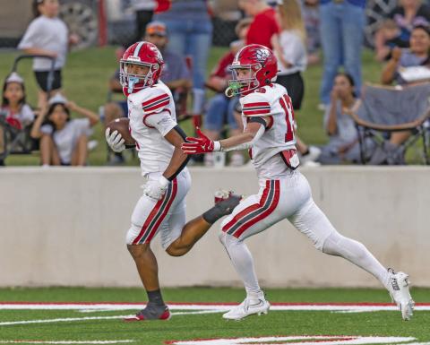 NRC’s Memphis Burdine (1) is escorted into the endzone by Reid Rollins (13). Photo/Rick Hester