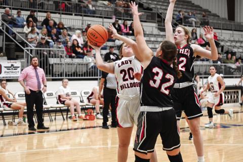 Meeker senior Lauren Miller gets double-teamed while putting up a shot against Luther during the Lady Bulldogs’ Senior Night game. Photo/Robyn Miller