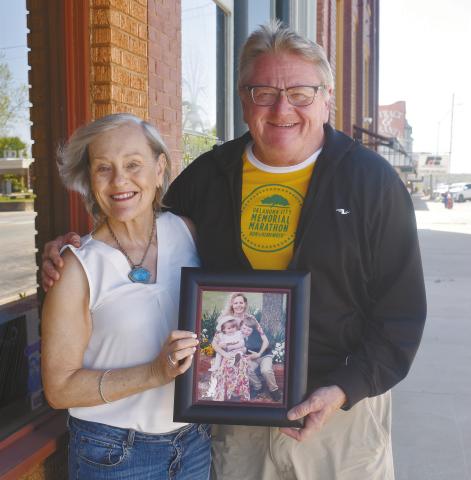 Cynthia Ferrell Ashwood (left) and Albert Ashwood stand outside The Lincoln County News office on Manvel in Chandler on April 11. They’re holding a photo of Cynthia’s sister, Susan Ferrell, who died in the Oklahoma City Bombing on April 19, 1995. Photo/Emily Kalka