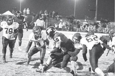 Holdenville’s special teams struggles to tackle Meeker senior Jarrett Marks following a lengthy punt return Friday night. Photo/Brian Blansett