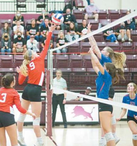 Right Hope Hanna scores a point for the Lady Cougars against Oklahoma Christian School.