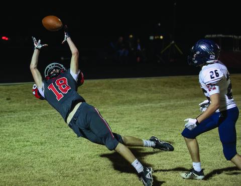 North Rock Creek’s Trey Bray, left, stretches for a tipped pass in the end zone against Metro Christian Thursday night. Metro won, 41-12, to finish the season with a perfect 10-0 record. Playing in a district for the time in NRC’s short history, the Cougars finished the season with a 3-7 overall record and a 2-5 district mark. Photo/Rick Hester