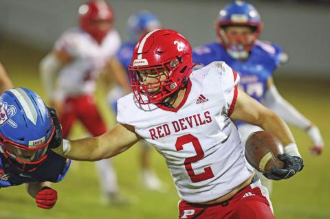 Prague running back Trevor McGinnis puts a stiff-arm on a would-be tackler from Oklahoma Christian. Photo/Rick Hester