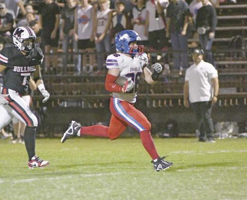 Carson Clagg (26) breaks into the clear on one of his four touchdown runs against Meeker Friday night. Photo/Brian Blansett