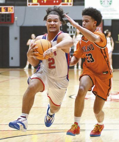 Jaydan Denson drives against Roland. Photo/Brian Blansett