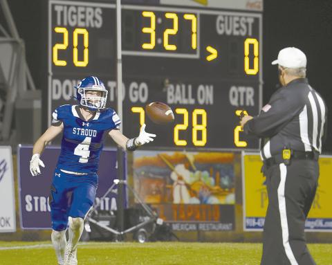 Jacob Beck (4) flips the ball to the referee after scoring a second-quarter touchdown Friday night. The Tigers won, 45-12, and move to the second round of the playoffs, hosting Salina at home Friday night. Photo/Beth Young