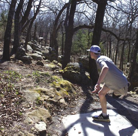 Chandler resident Landon Gray lets his disc fly on a hole affectionately called “The Rattlers” at Stroud’s The Nest Disc Golf Course. The hole gets its name from the rock formations that resemble the pygmy rattlers that live in the area. Photo/Emily Kalka