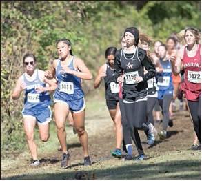 Below top, Stroud junior Gabi Morris (1411) runs through a patch of sunlight.