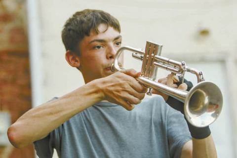 Chandler senior Landon Gray focuses as he plays the trumpet upside down. He is a member of the Chandler marching band, The Pride of Chandler, and often volunteers to play TAPS at the funerals of veterans. Photo/ Jennifer Pryor