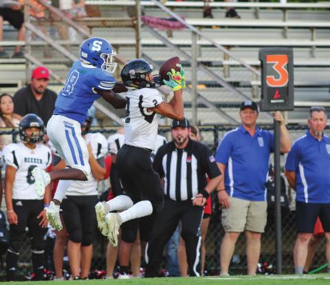 Above, Meeker freshman Manny Saavedra intercepts a pass that the returned for a touchdown against Stroud. Photo/Rick Hester. Below, North Rock Creek freshman Caleb Hawkins scoops a blocked field goal in overtime for the Cougars against Heavener. He returned it 85 yards for the winning touchdown. Photo/Kindra Blansett