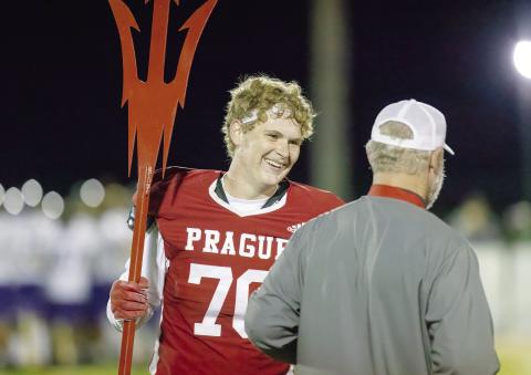 Prague senior Dillon Cooper talks with Coach Rafe Watkins after the Red Devils’ district-clinching win over Vian Friday night. Photo/Rick Hester