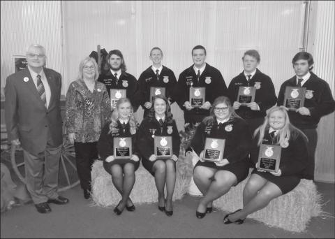 Jamie Barrick and Gordon Richards, Jr., standing far left, of Richards Drug Stores, presented nine FFA students with their awards Monday night during the 75th annual Richards FFA Banquet. Recipients of the award sitting from left to right are Jesse Moore, Macomb, Terah Garcia, Asher, Dassie May, Shawnee and Maycee Spain, McLoud. Standing left to right are Konnor McKey, North Rock Creek, Colton Ingmire, Bethel, Jacob Nunley, Tecumseh, Shane Rodman, Wanette and Paden Thomas, Dale. Photo/ Jennifer Pitts
