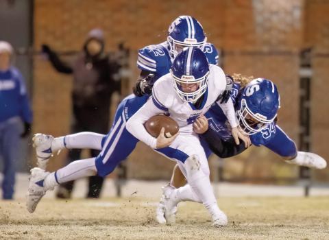 Stroud’s Chandler Davis (52) and Ty Stafford (54) wrap up the Commerce quarterback for a sack. Photo/Rick Hester