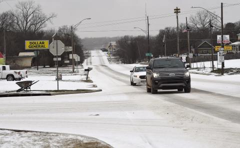 A thundersleet storm moved through the area Monday morning, coating roads and parking lots and forcing many area schools to close in-person classes and go to virtual classrooms. This scene is looking east on state Highway 62 from the four-way in Meeker. Photo/Brian Blansett