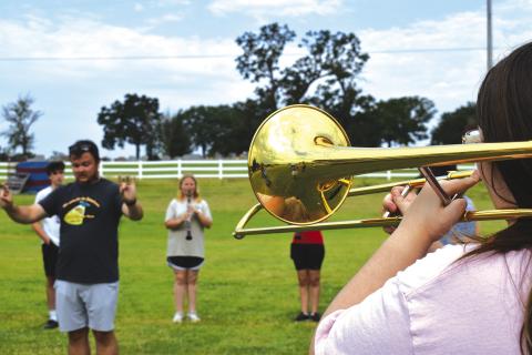 Chandler Band Director Zachary Fisher directs members of the Pride of Chandler marching band through warm-ups at band camp on July 31. Photo/Emily Kalka