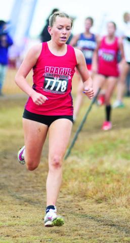 Prague sophomore Jocelyn Ward on her way to a second-place finish Saturday at the state cross country meet at North Rock Creek. She ran a 12:03.1 to help lead the Prague team to third place. Runners from Chandler, Stroud, Davenport, North Rock Creek and McLoud competed. For more, see Page 1C. Photo/Brian Blansett