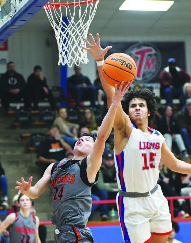Chandler center Zalen Smith prepares to reject a shot by Morris’s Xavier Harjo (24) during district action Saturday night in Chandler. The Lions won, 69-66, to advance to Saturday night’s regional finals. The Lions, the North Rock Creek boys and the top-ranked Dale boys and girls all won district championships and move into the winner’s brackets in this week’s regional tournaments. See Pages 2C-4C for more basketball. Photo/Brian Blansett