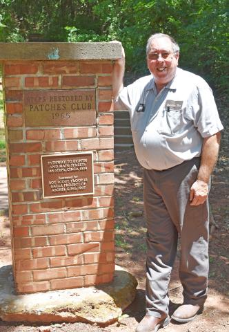 Howard Dickman, owner of Chandler Tire Center, stands next to a pillar marking the restored stairs leading up the hill where the old Oklahoma National Guard warehouse was located. After over 20 years of work, Dickman’s research led to the designation of Chandler as the hometown of the National Guard. Next on Dickman’s list is to replace and restore plaques and monuments at National Guard sites in town. Photo/ Emily Kalka