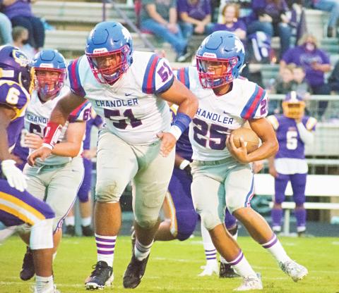 Cazmen Hill (25) runs behind a block by offensive lineman Traydon Richardson (51) against Bristow. Photo/Chelsea Weeks