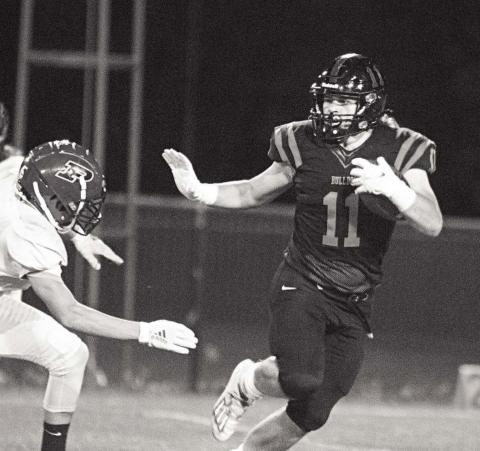 Davenport’s Parker Mitchell (11) drops a Heisman move on a Prue defender during the Bulldogs’ 56-6 victory. Photo/Chelsea Weeks