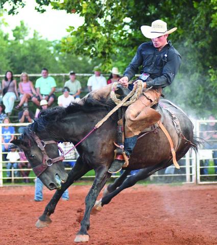 Maverick Porter weathers a sideways buck from his bronc during the Friday night performance to win the ranch bronc riding and pocket $342 in prize money. Photo/Brian Blansett