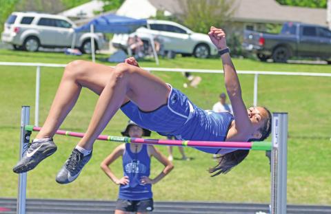 Above, defending state champion Kileigh Mixon keeps her eyes on the bar as she clears 5-6 in the high hump Saturday at the Stroud regional. Below, pole vaulter Drew Clovis from Stroud easily clears his bar. See Page 3C for more photos. Photos/Brian Blansett