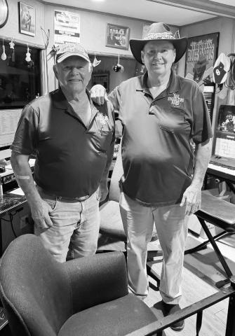 Joe Navrath (left) and Danny Clement pose in the Sugar Time music studio. Below, Austyn Denmore, with his rockstar haircut, holds his electric guitar. Photos/Bradey Jager