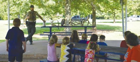 Game Warden Jacob Harriet speaks at a library event in Tilghman Park. Photo/Emily Kalka