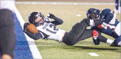 Meeker’s Cam Holts (12) eyes the goal line as he clears the plane Friday night against Metro Christian. Photo/Brian Blansett