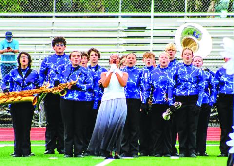 Members of the Pride of Chandler marching band shout before entering the field at the OSSAA Southeast Regionals in McAlester on Oct. 14. From left to right, Julia Gardner, Gavin Moore, JD Simpson, Ylenia Morris, Alex McDaniel, Karyss Campbell, Caroline McDonnell, Jareth Brown, Chloe Gross, Connar Russell, Lauren Aylward and Anna Schlegel. Photo/Landon Gray