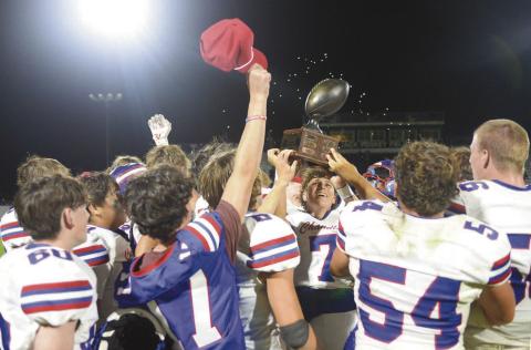 Chandler players hoist the BancFirst Historic Route 66 Bedlam Classic trophy after winning the rivalry game with Stroud, 13-8, Friday night. For more on the game and area sports, please see Section C and Page 1D. Photo/Brian Blansett