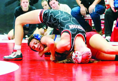 Chandler sophomore Lizzy Pryor (in red and white) nears a pin against Abigail O’Kelly of Yukon during the Wrestle Like a Girl meet at Cache. Pryor took fourth in her class and McKinley Miller won sixth. See more wrestling photos on Page 3D. Photo/Jennifer Pryor