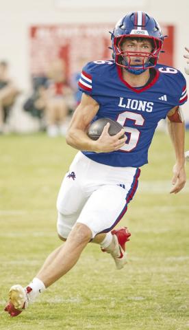 Chandler quarterback Chace Buchanan looks upfield during a long run in the first quarter. Photo/Brian Blansett