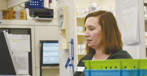 Melissa Covington, a pharmacist at Hite’s Drug, prepares a prescription. Her sister, Megan Jones, also a pharmacist at Hite’s Drug, said they’ve seen roughly the same number of flu and COVID-19 shots this year. Photo/Emily Kalka