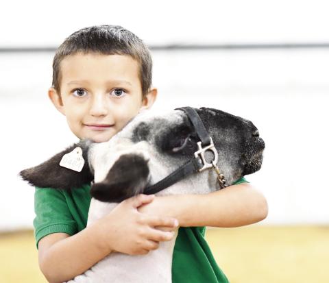 Meeker third-grader River Potts gives his sheep, Diva, a hug before the Meeker local livestock show Saturday. The spring show season is in full swing, with several schools having local shows and the Lincoln County show this week. The Pott County livestock show will be in two weeks. For photos and results from the Meeker, Chandler and Wellston local shows, please see Pages 1D and 3D. Photo/Brian Blansett