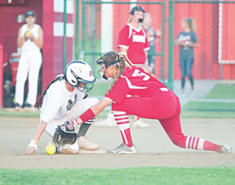 Right, Diana Manning (in red) reaches for a throw at second against Meeker in the regional tournament. Archive photo/Brian Blansett