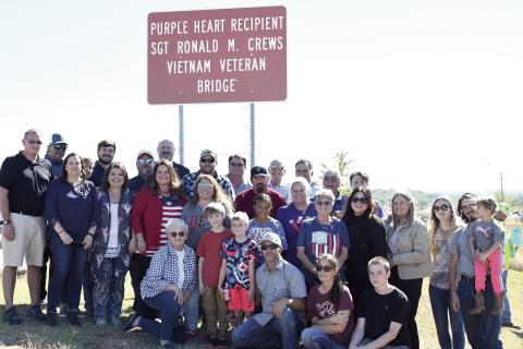 The family of former Chandler resident Ronald M. Crews gathered with state Rep. Kevin Wallace Friday for the renaming of the bridge on state Highway 18 over the Turner Turnpike in Chandler. Sgt. Crews is an Army veteran of two tours in Vietnam, where he was seriously wounded. Photo/Brian Blansett