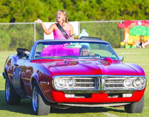 Keira Bizzell laughs and blows a kiss to her fans in the stands during Homecoming festivities at Meeker Friday. A senior, she was crowned Homecoming Queen for 2024.