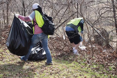 Three participants in the community sentencing program through Oklahoma Court Services pick up trash along Route 66 on Feb. 25. OSC arranges such activities at least once a month to help participants give back to the community. Two other groups did trash pick-up in Wellston and Stroud. Photo/Emily Kalka