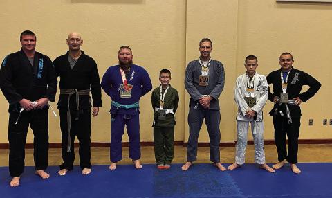 Left to Right: Competitor Travis Pearman; Coach Bret Smithey; Shawn Brake, Gold Open Weight Class; Eli Pearman, Silver; Nate Soderstrom, 1 Silver and 1 Gold; Boethius Penny, 2 Gold; A.J. Penny, Silver. Not pictured: Athanasius Penny, Bronze