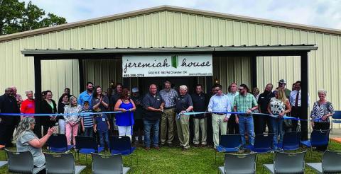 Mike Bates, Founder/CEO of Jeremiah House, cuts the ribbon at 343016 E. 980 Road during ceremonies last week sponsored by the Chandler Area Chamber of Commerce.