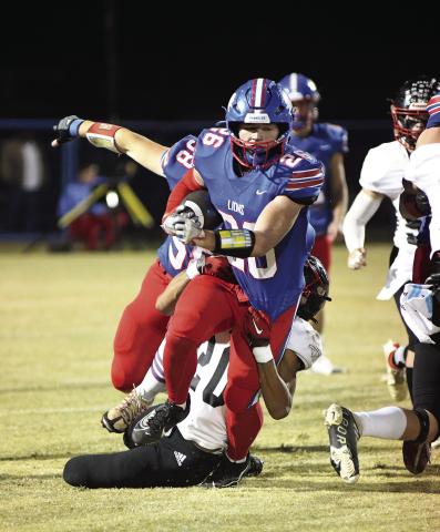 Upper left, Cruz Jackson hauls in a touchdown pass Friday against Luther and, above, Carson Clagg tows a Luther tackler in the first half. Jackson had 62 yards rushing and 66 yards and a touchdown receiving. Clagg carried 30 times for 203 yards. Photos/Brian Blansett