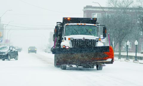 Downtown Chandler looked like Minnesota for a while on Sunday as snow flakes fell and gravel trucks and blades moved through. See the article on Page 2A. Photo/Brian Blansett
