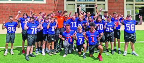 The Chandler Junior High football team went into full Pistols Firing mode last week during a tour of the Oklahoma State University football facilities. The team got to see the weight room, film room, coaches offices, meeting rooms, athletic cafeteria, indoor practice field and Boone Pickens Stadium. After eating, the team was playing football on the outside turf field and OSU head coach Mike Gundy walked by and took this picture with them.