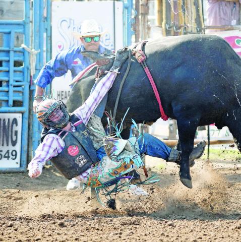 Bullrider Ryker Butler from McLoud got hung up briefly during the second round of the International Finals Youth Rodeo Friday morning in Shawnee. The defending champion, Butler was one of a contingent of local youths competing in the rodeo. For more, please see Page 1C. Photo/Brian Blansett