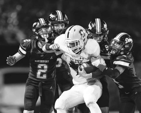 The Olive ball carrier has no chance to get away from a pack of Dawgs, from left Tyler Gilkison (2), Jaxson Brinkley (6), Brody Robinson (9) and Devin Murfin (4). Photo/Rick Hester